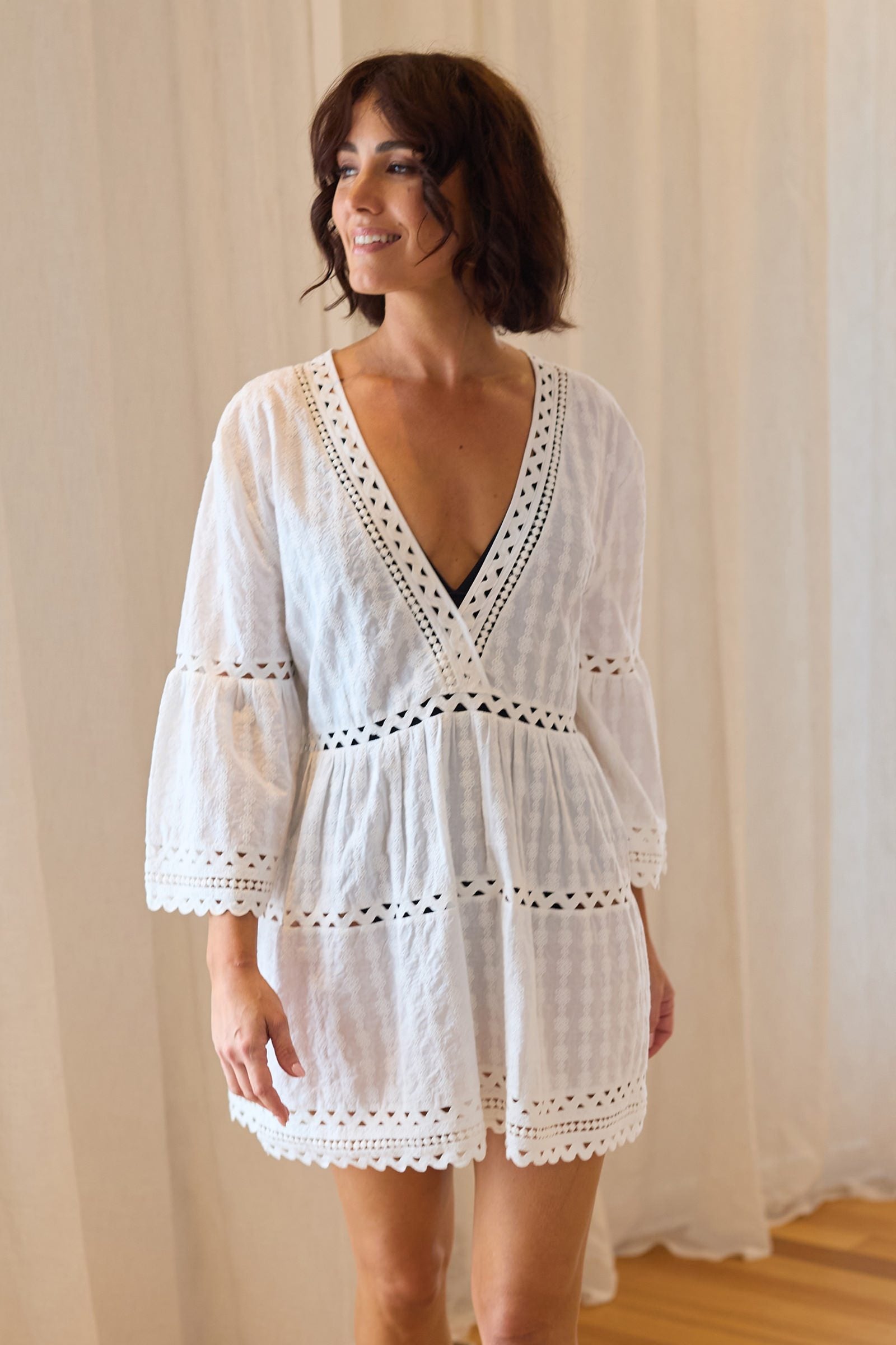 This model wears UNE PIECE Embroidered Kaftan Dress in Black, featuring soft breathable cotton and flounced sleeves for an effortless summer resort aesthetic.